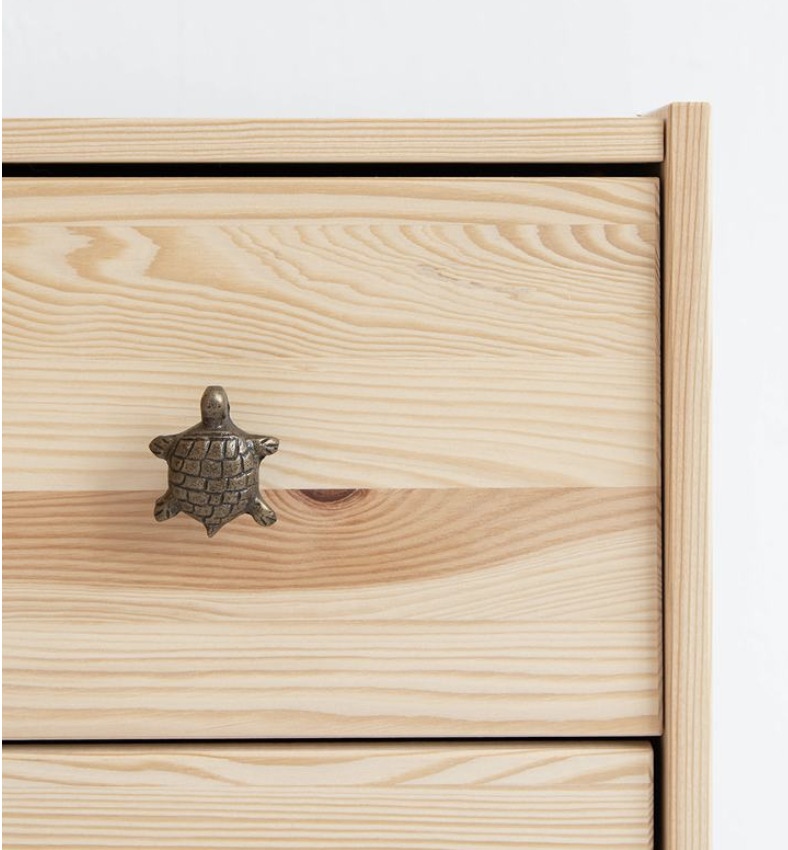 A turtle-shaped drawer handle