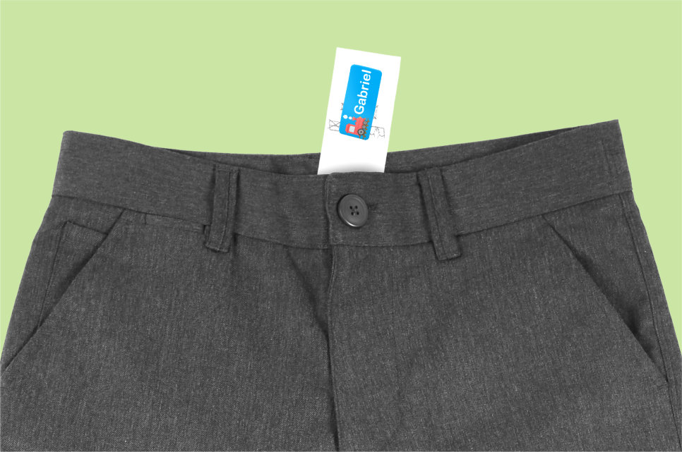 A personalised name label attached to a clothing care label