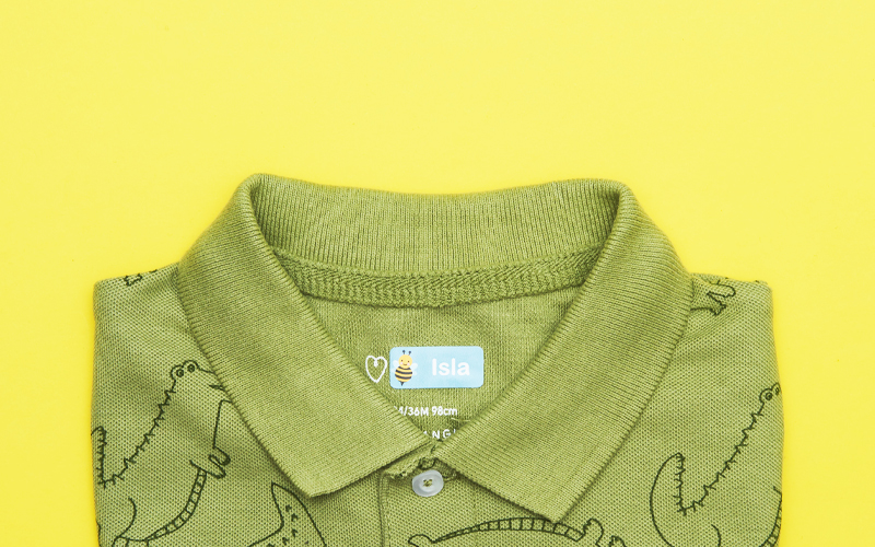 Green polo shirt with a My Nametags label in the collar on a yellow background