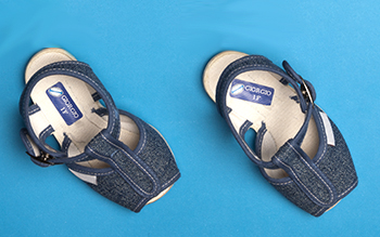 Shoe name tags on sandals on blue background